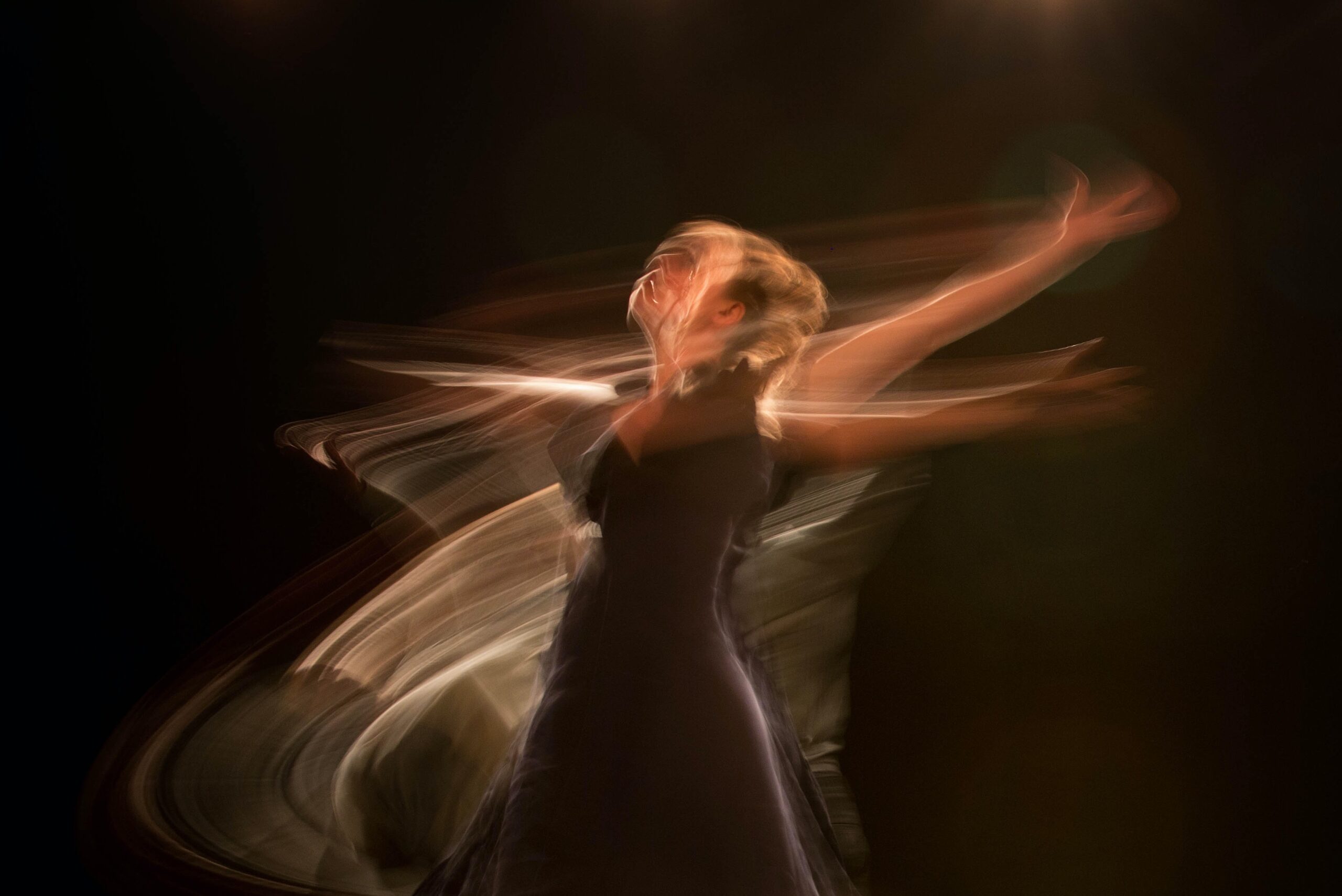 Woman dancing in a dark room